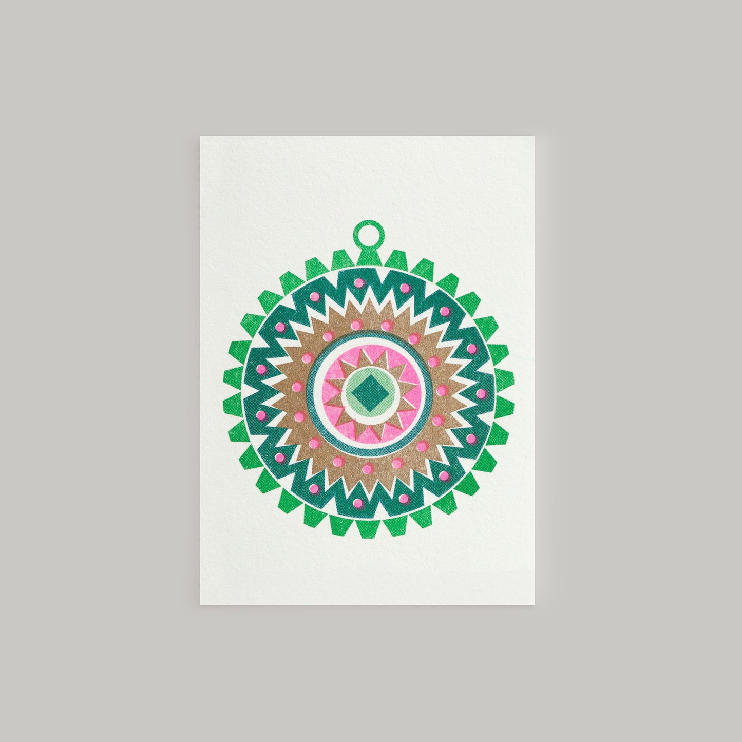 A Scandi style mini Christmas greeting card featuring a geometric pattern with bright pink and metallic gold inks, and a small Christmas tree ornament design in the center. The card has a white background and a contrasting envelope.