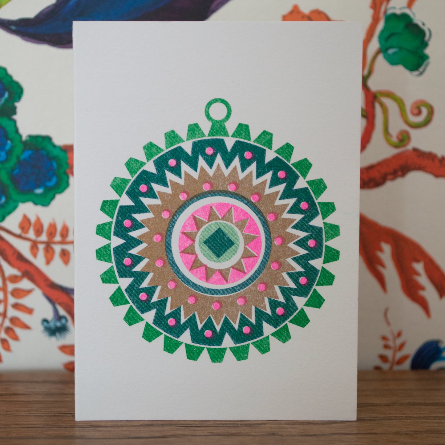 A little Christmas card ideal for design-conscious friends and family who appreciate modern festive details, a Scandi style Bauble is printed in bright green, pink and gold risograph ink.