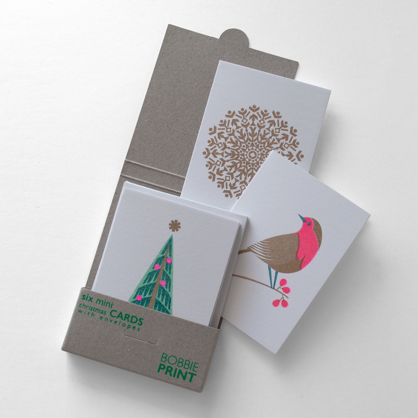 A Pack of Six Mini Retro Style Christmas cards with envelopes featuring a cute little robin, nordic style fir tree and snowflake