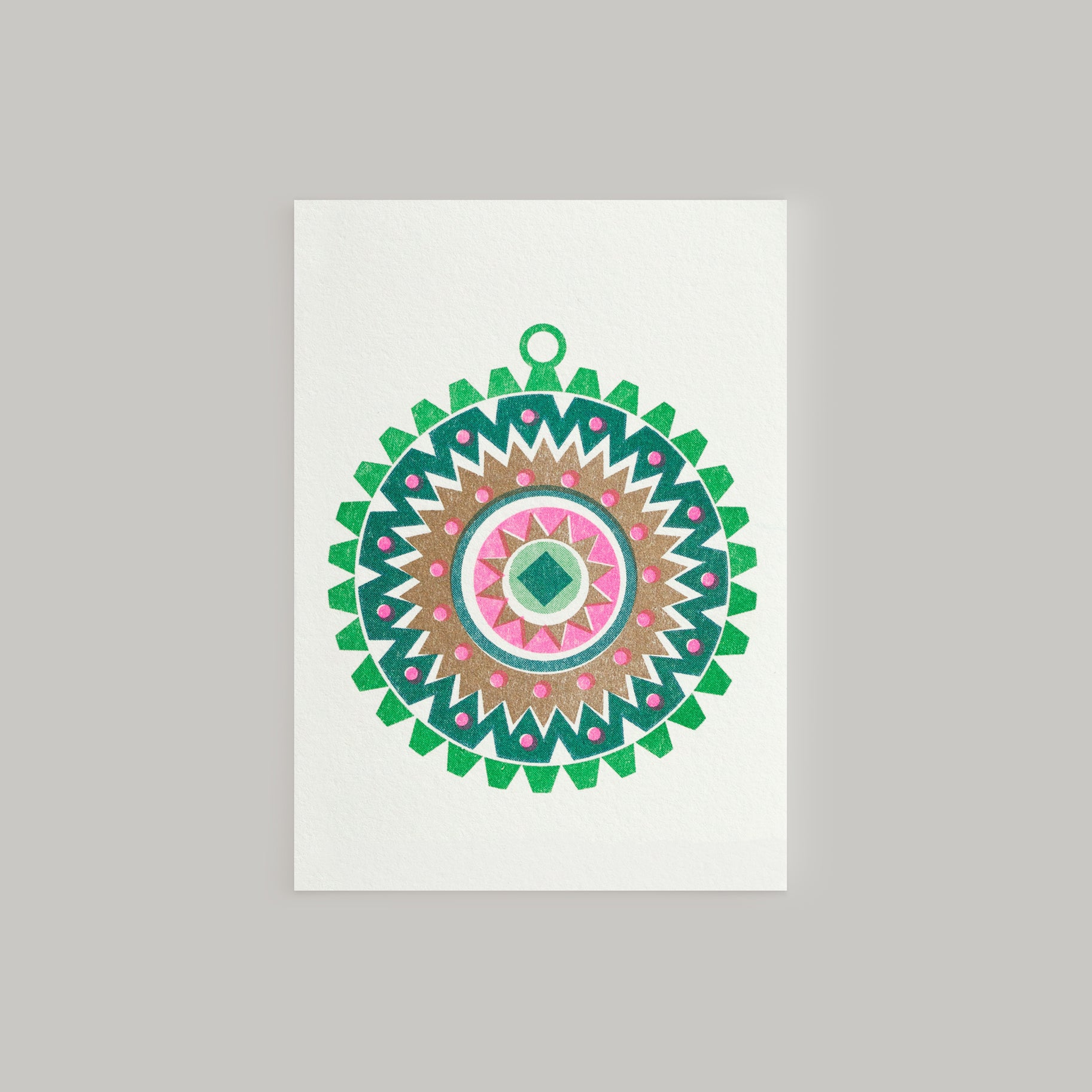 A Scandi style mini Christmas greeting card featuring a geometric pattern with bright pink and metallic gold inks, and a small Christmas tree ornament design in the center. The card has a white background and a contrasting envelope.