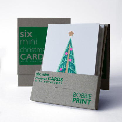Boxed collection of six mini Christmas cards with envelopes featuring a retro style, nordic Christmas tree. The Christmas card set is packaged in a screen printed box.