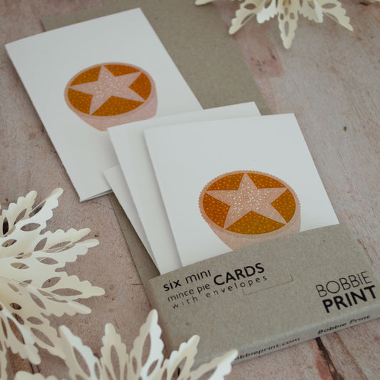 Boxed set of mini Christmas cards featuring a foodie themed mince pie illustration. Pack of six cards with envelopes packaged in a tiny box.